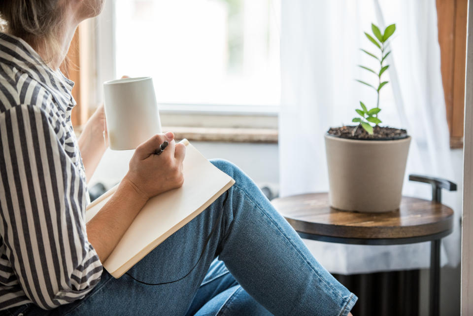 Journalling or reading can help alleviate overwhelming feelings of stress during self-isolation.  (Image via Getty Images).