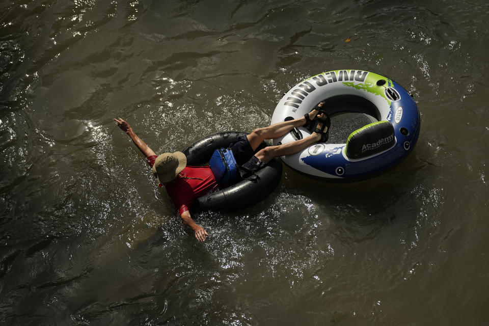 FILE - A tuber floats on the Comal River, July 26, 2023, in New Braunfels, Texas, as the area continues to feel the effects of triple-digit temperatures. Record setting temperatures are expected Saturday, Aug. 19, across Texas as the southwestern U.S. continues to bake during a scorching summer. (AP Photo/Eric Gay, File)