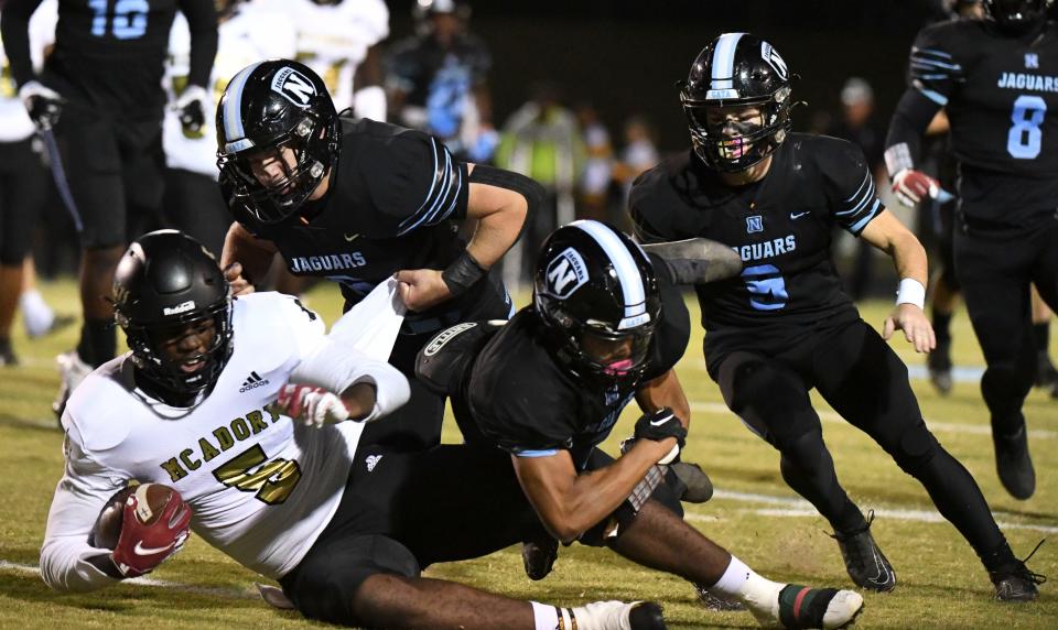 Sep 30, 2022; Tuscaloosa, AL, USA;  McAdory's Jacorey Whitted (5) is tackled by a trio of Northridge defenders at Northridge High School. 