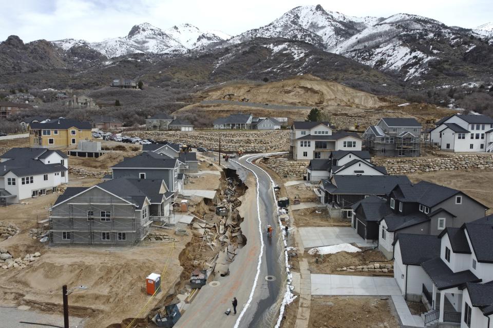 Local officials issued evacuation orders for at least 20 homes as temperatures spiked and snowmelt coursed through the streets on Wednesday, April 12, 2023, in Kaysville, Utah. (AP Photo/Rick Bowmer)