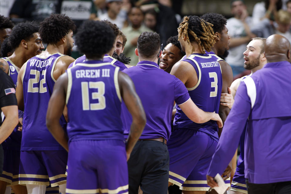 James Madison players celebrate during overtime in an NCAA college basketball game against Michigan State, Monday, Nov. 6, 2023, in East Lansing, Mich. (AP Photo/Al Goldis)