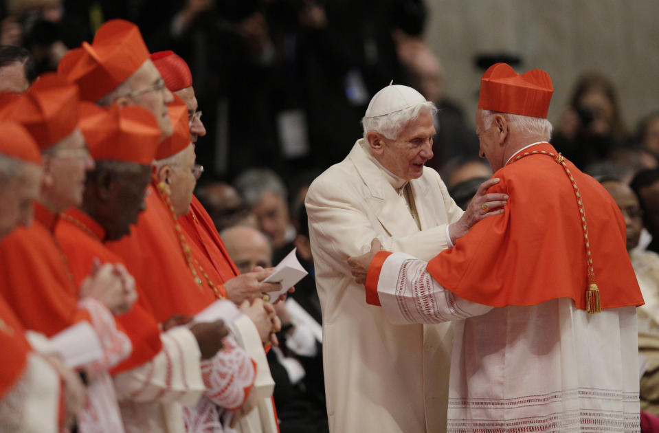 Newly-elected Cardinal Ricardo Ezzati Andrello, right, is greeted by Pope Emeritus Benedict XVI after he received the red three-cornered biretta hat during a consistory inside the St. Peter's Basilica at the Vatican, Saturday, Feb.22, 2014. Pope Francis is putting a personal imprint on the group of men who will choose his successor, tapping like-minded cardinals from some of the world's smallest, most remote and poverty-wracked nations to help him run the Catholic Church. (AP Photo/Alessandra Tarantino)