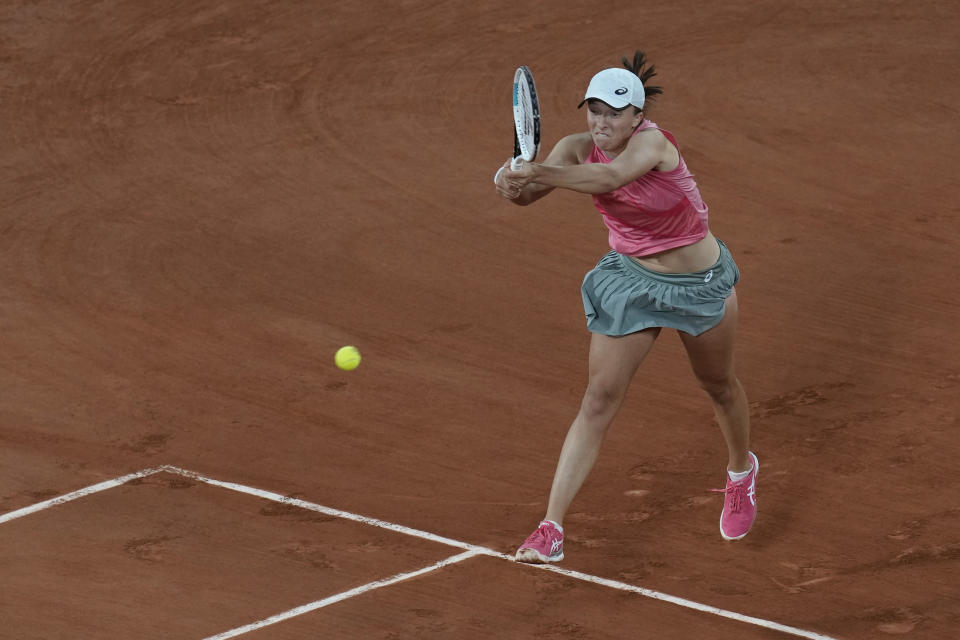 Poland's Iga Swiatek plays a return to Ukraine's Marta Kostyuk during their fourth round match on day 9, of the French Open tennis tournament at Roland Garros in Paris, France, Monday, June 7, 2021. (AP Photo/Christophe Ena)