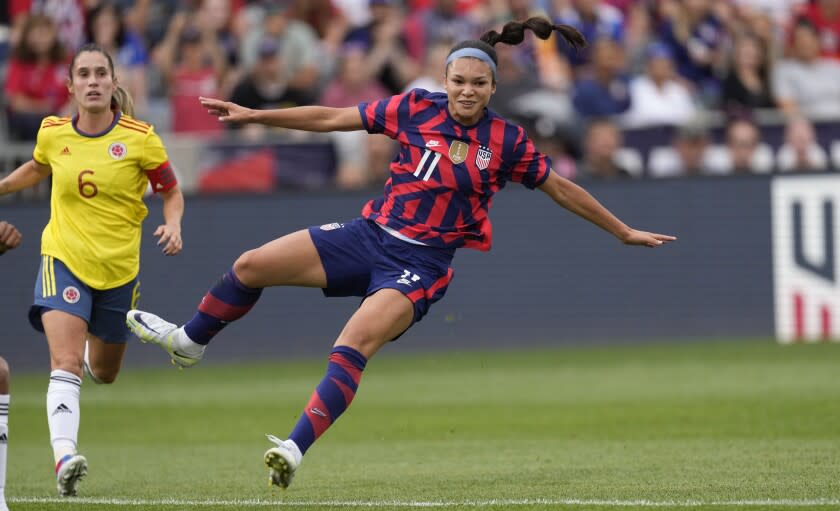 U.S. forward Sophia Smith, front, comes back down to the pitch after kicking the ball, next Colombia midfielder Daniela Montoya during the first half of an international friendly soccer match Saturday, June 25, 2022, in Commerce City, Colo. (AP Photo/David Zalubowski)