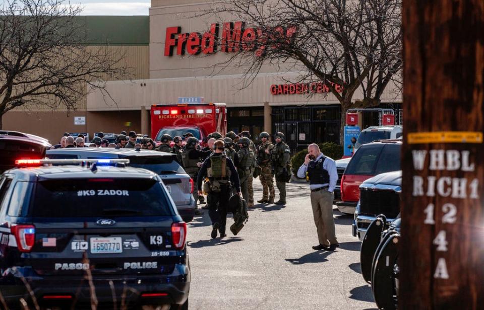 Authorities stage outside a Fred Meyer grocery store after a fatal shooting at the business on Wellsian Way in Richland, Wash., Monday, Feb. 7, 2022.