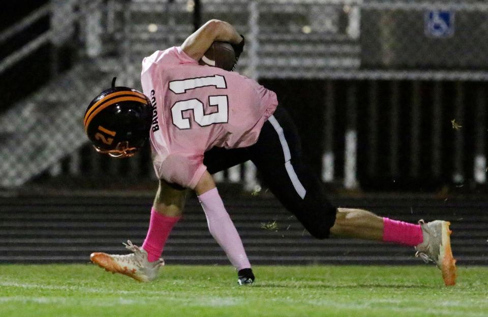 Mishicot football player Adam Backus (21) suffered a life-threatening injury in practice last season but was able to return for his senior season.