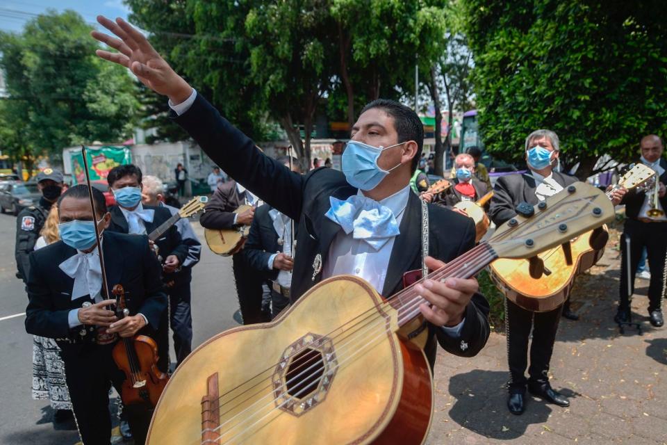 A mariachi band serenades the National Institute of Respiratory Diseases (INER) in Mexico City, on April 7 to give hope to those fighting COVID-19 and the medical personnel during the coronavirus pandemic.