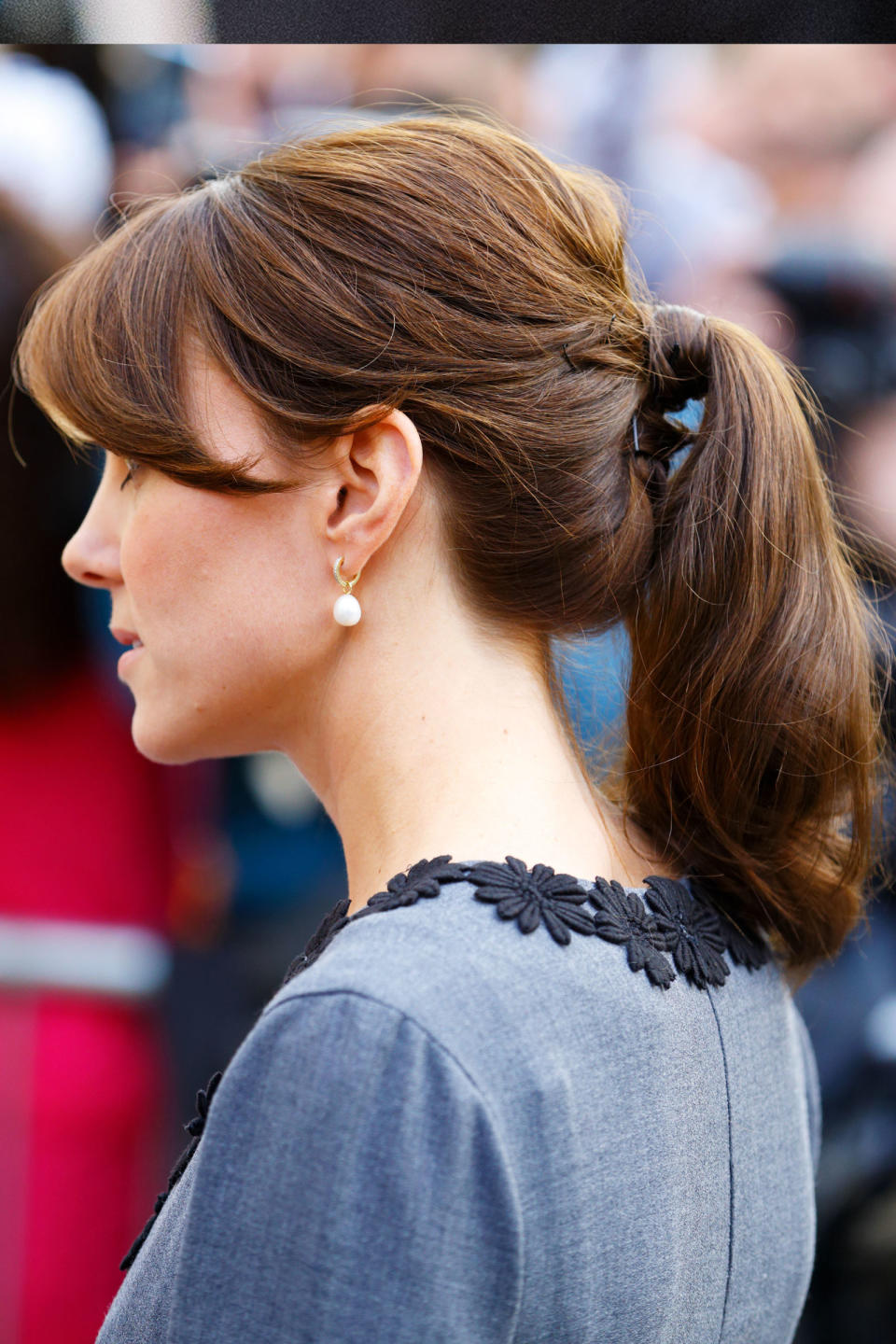 <p>She swept her bangs to the side and pulled her hair into a simple, mid-pony. </p>