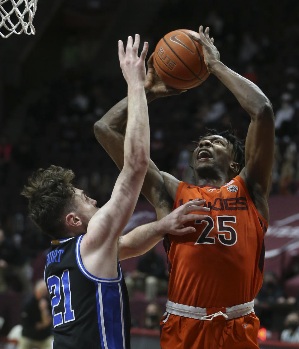 Virginia Tech's Justyn Mutts (25) scores past Duke's Matthew Hurt (21) during the first half of an NCAA college basketball game Tuesday, Jan. 12, 2021, in Blacksburg, Va. (Matt Gentry/The Roanoke Times via AP, Pool)