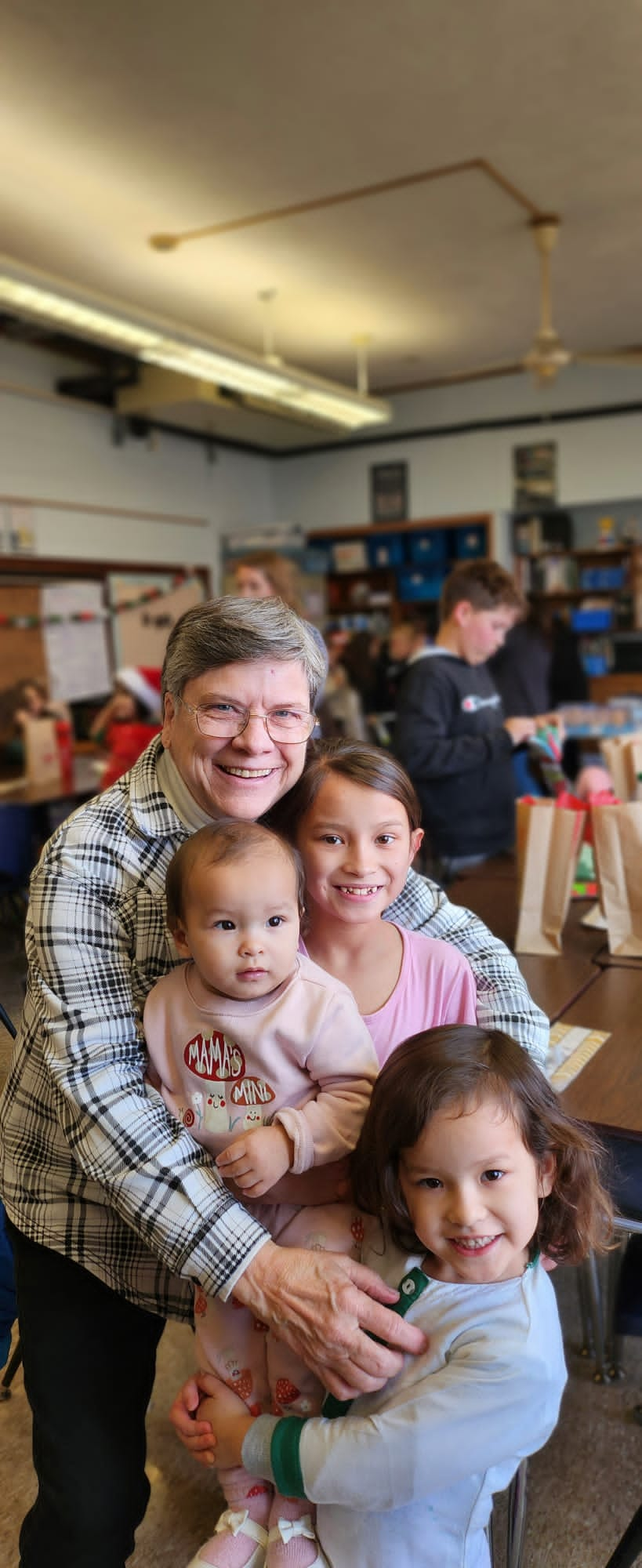 Linda Pegg, a retired nurse, has helped several Afghan refugees settle into Springfield, including children Kawsar, Maryam, and Fatima Zahra Rahimi.