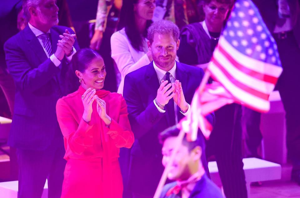 Meghan, Duchess of Sussex and Prince Harry, Duke of Sussex clapping during the Opening Ceremony of the One Young World Summit 2022