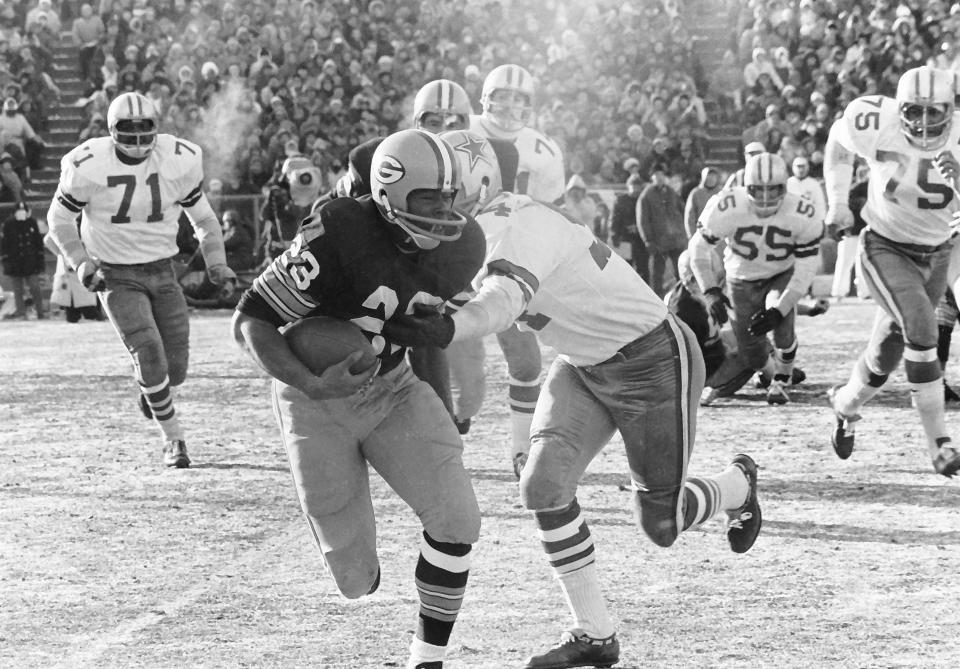 Green Bay Packers running back Travis Williams (23) tries to evade Dallas Cowboys linebacker Chuck Howley (54) during the Ice Bowl, also known as the NFL Championship Game, on Dec. 31, 1967, at Lambeau Field. At minus-13 degrees, with a minus-48 wind chill, the Ice Bowl remains the NFL's coldest game ever.