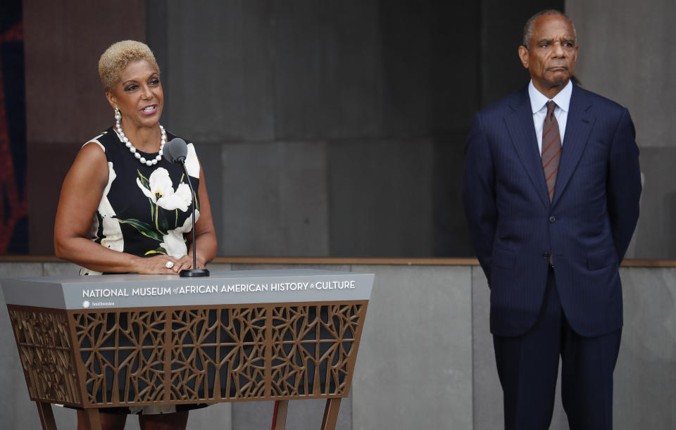 FILE - In this Sept. 24, 2016 file photo Linda Johnson Rice, left, Chairman, Johnson Publishing Company, Inc., and Publisher of Ebony and Jet magazines, is joined by Kenneth Irvine Chenault, right, CEO and Chairman of American Express, at the dedication ceremony for the Smithsonian Museum of African American History and Culture on the National Mall in Washington. The new owners of the Ebony and Jet photo archive, Darren Walker as president of the Ford Foundation and Elizabeth Alexander, president of the Andrew W. Mellon Foundation, promised on Thursday, July 25, 2019, to donate the more than 4 million prints and negatives from the iconic black magazines to the Smithsonian National Museum of African American History and Culture and the Getty Research Institute. (AP Photo/Pablo Martinez Monsivais, File)