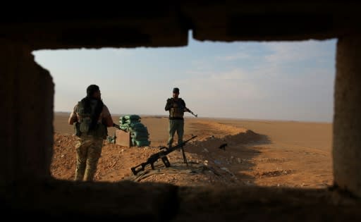 Iraqi Shiite fighters of the Hashed al-Shaabi paramilitary force secure the border area with Syria in al-Qaim in Iraq's Anbar province late last year