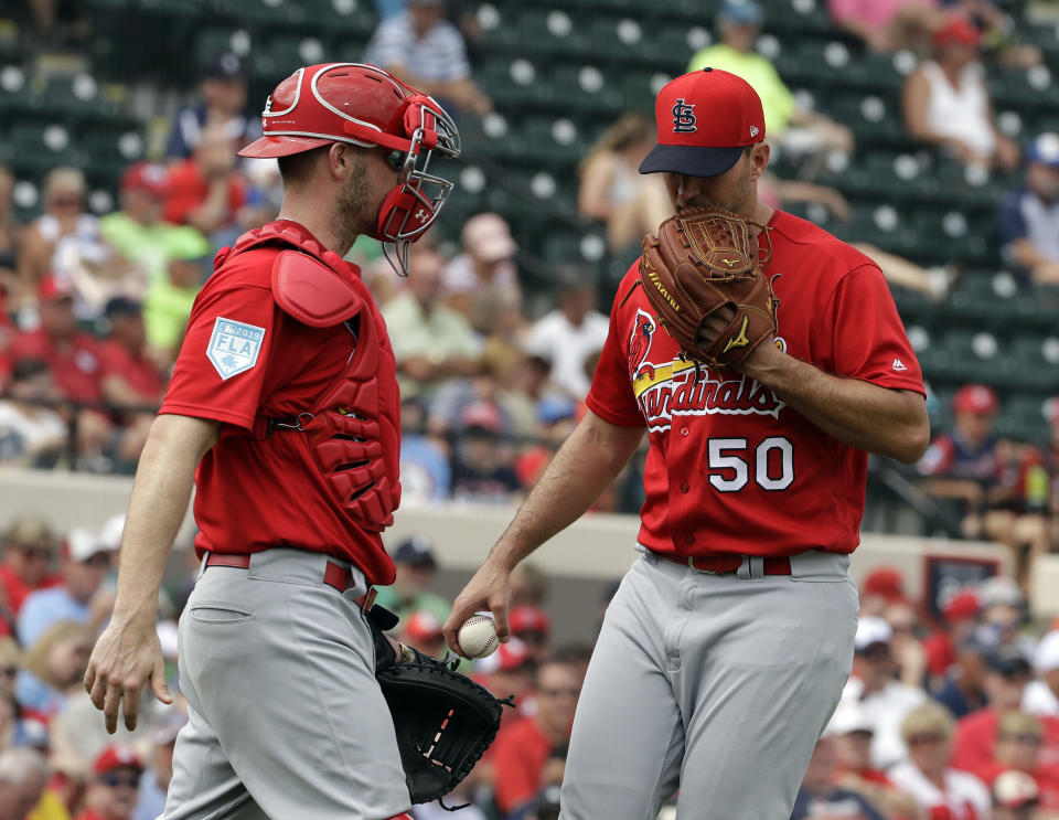 St. Louis Cardinals catcher Matt Wieters, left, talks to starting pitcher Adam Wainwright during the third inning of a spring training baseball game against the Detroit Tigers Monday, March 4, 2019, in Lakeland, Fla. (AP Photo/Chris O'Meara)