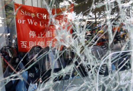 Riot police is seen inside the Legislative Council building where protesters try to break into, during the anniversary of Hong Kong's handover to China in Hong Kong