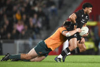 New Zealand's Richie Mo'unga is tackled by a defender the Bledisloe Cup rugby test match between the All Blacks and the Wallabies at Eden Park in Auckland, New Zealand, Saturday, Sept. 24, 2022. (Andrew Cornaga/Photosport via AP)