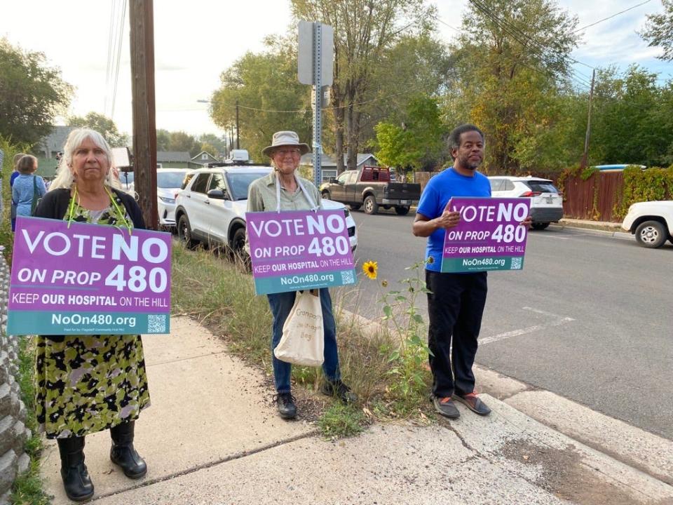 Residents who oppose the new hospital plan hold signs outside of Northern Arizona Healthcare's public forum on Sept. 27, 2023, in Flagstaff.