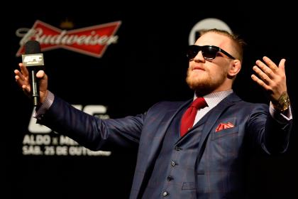 Conor McGregor plays the crowd before the UFC 179 weigh-in. (Getty)