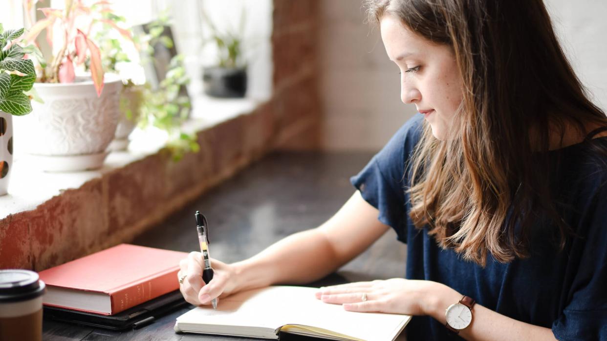 Woman writing in journal