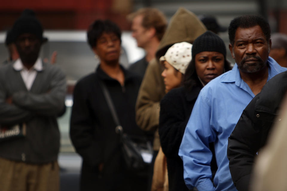 Residents of the historically African American neighborhood of Harlem wait in line to vote.