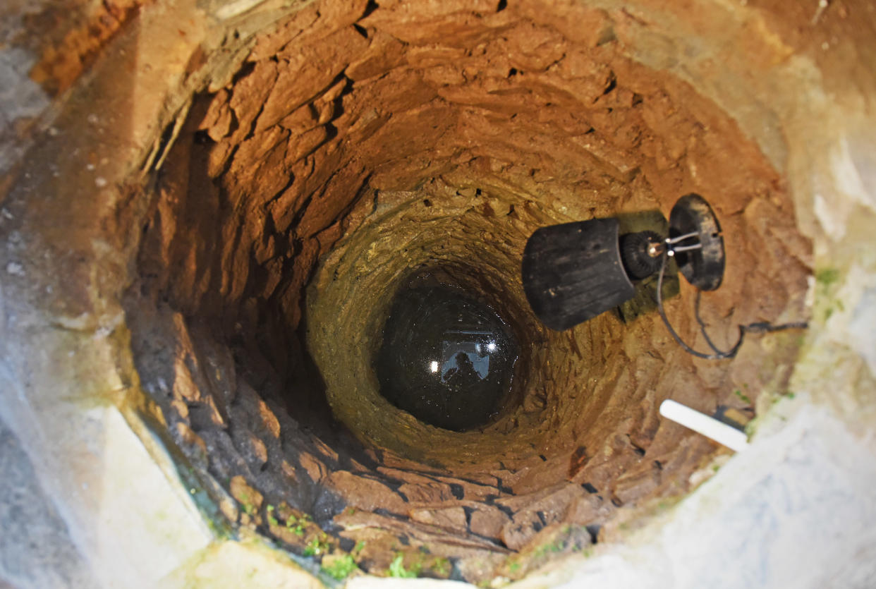 CATERS NEWS (PICTURED - The 17ft medieval well in Colin Steer's living room) - A grandad has spent the last decade digging out a 17ft deep medieval well in his living room after noticing a slight dip in the floor when redecorating. Colin Steer, from Plymouth, discovered the well after he noticed a dip in the floor while redecorating his living room ten years ago and has since spent the last decade digging out the 17ft well. The 70-year-old believes that the well could date back to medieval times after discovering an old sword while digging out the well and plans of the site suggests that the well could date back to the 1500s. Colin said: 