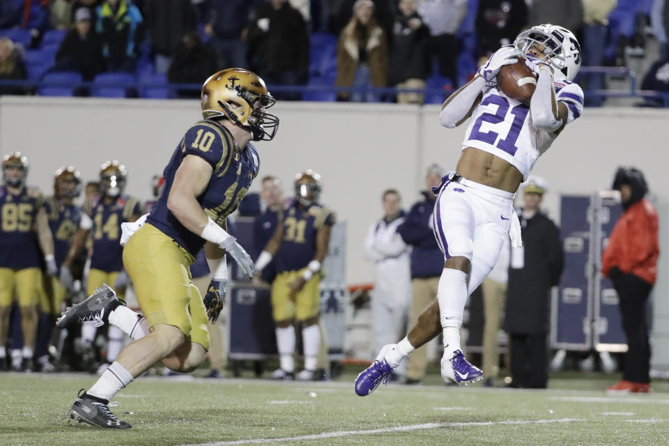 Kansas State wide receiver Wykeen Gill (21) catches a pass ahead of Navy safety Kevin Brennan (10) for a 42-yard gain in the second half of the Liberty Bowl NCAA college football game Tuesday, Dec. 31, 2019, in Memphis, Tenn. Navy won 20-17. (AP Photo/Mark Humphrey)