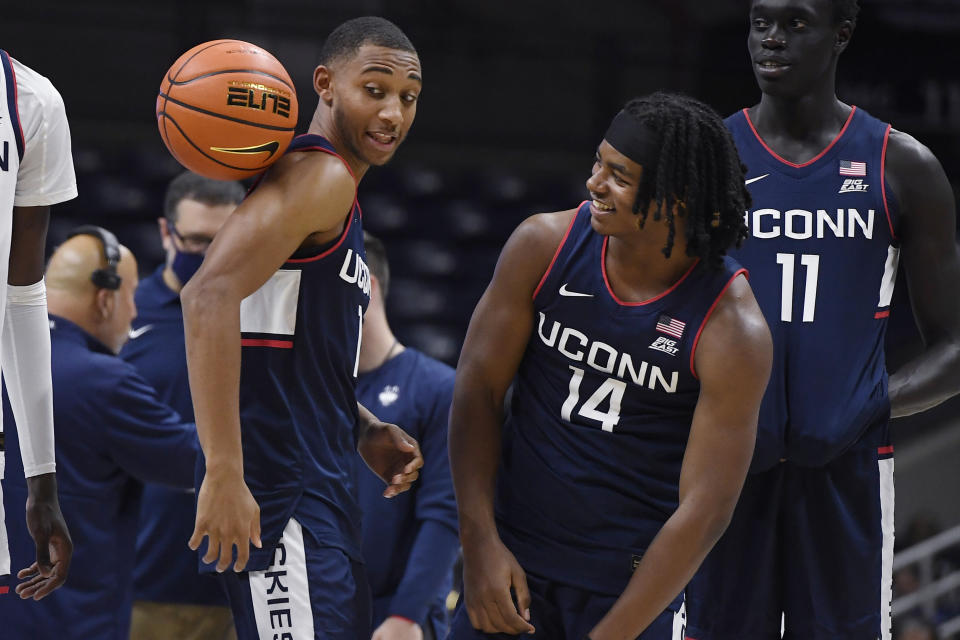 Connecticut's Rahsool Diggins, left, and Corey Floyd, Jr., right, have a playful moment during First Night events for the UConn men's and women's NCAA college basketball teams Friday, Oct. 15, 2021, in Storrs, Conn. (AP Photo/Jessica Hill)