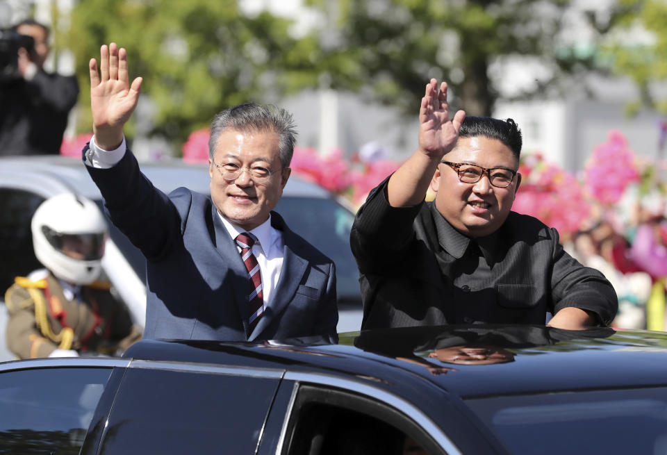 FILE- In this Sept. 18, 2018 file photo, South Korean President Moon Jae-in, left, and North Korean leader Kim Jong Un ride in a car parade through Pyongyang in North Korea. Kim and Moon announced in the North Korean capital of Pyongyang this week that Kim has accepted Moon’s request to visit Seoul soon, maybe within the year. (Pyongyang Press Corps Pool via AP, File)