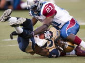 Montreal Alouettes Wopamo Osaisai(21) tackles Winnipeg Blue Bombers Jeremy Blount during first quarter Canadian Football League pre-season action Thursday, June 14, 2012 in Montreal. THE CANADIAN PRESS/Ryan Remiorz