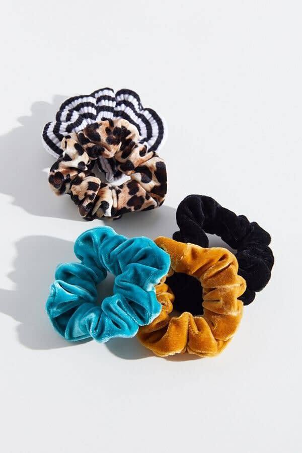 One look that's easy enough to pull off with little to no effort is the scrunchie. The scrunchies of fall and winter 2019 are made of luxe fabrics like corduroy and velvet, and they come in trendy prints like cheetah and polka-dots. Wear them in a high loose bun, or tie back your strands into a sleek, tight pony. Either way, you'll be on-trend without even trying. (Pictured: <strong><a href="https://fave.co/32y6qeA" target="_blank" rel="noopener noreferrer">Urban Outfitters Velvet Hair Scrunchie Set in Animal Print Multi</a></strong>)