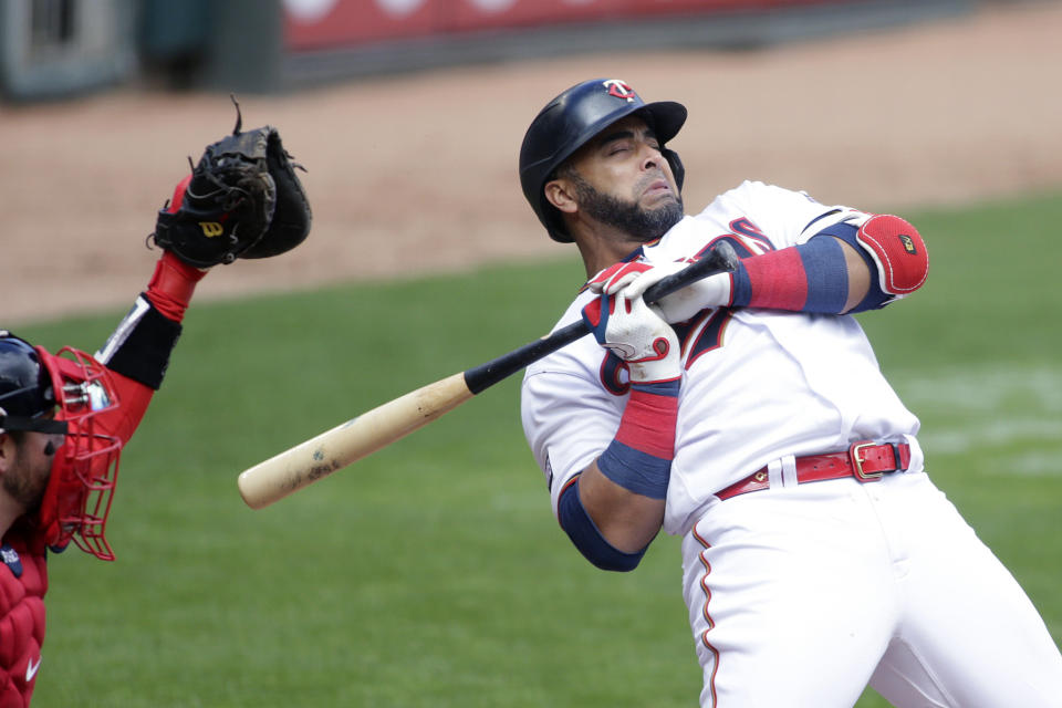 Minnesota Twins designated hitter Nelson Cruz reacts after getting hit by a pitch from Boston Red Sox starting pitcher Nathan Eovaldi in the first inning of a baseball game, Wednesday, April 14, 2021, in Minneapolis. (AP Photo/Andy Clayton-King)