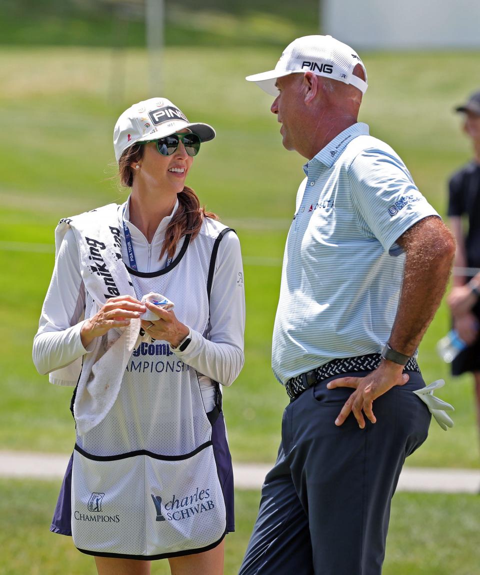Stewart Cink and his wife, Lisa, chat on No. 8 Thursday during the opening round of the 2023 Kaulig Companies Championship at Firestone Country Club in Akron.