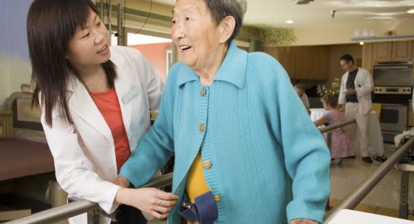 Woman helping patient at rehabilitation center