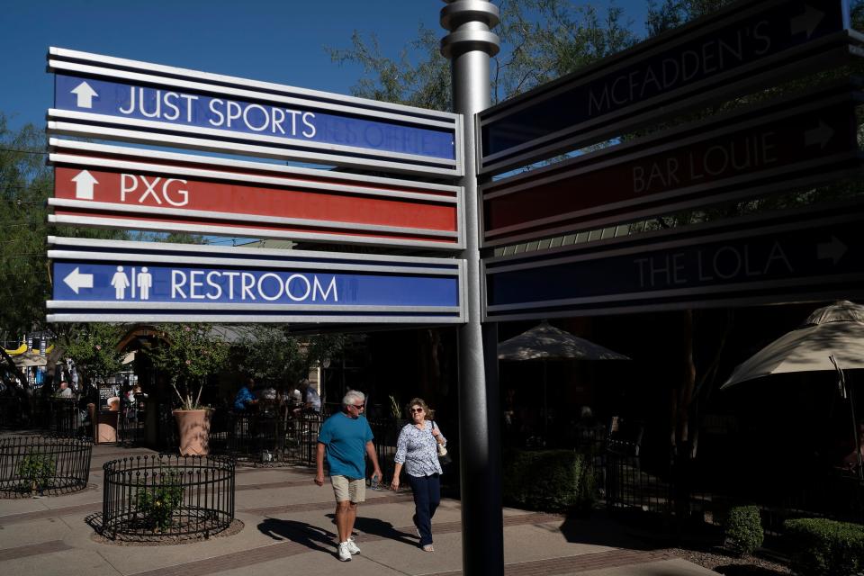 People walk around the Westgate Entertainment District on Black Friday on Friday, Nov. 26, 2021, in Glendale.