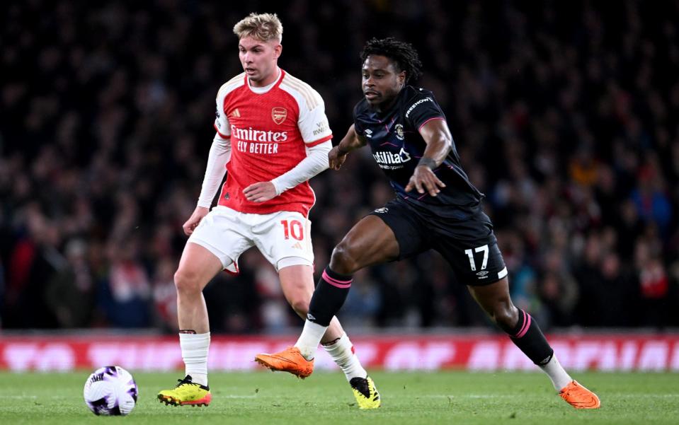Emile Smith Rowe of Arsenal and Pelly Ruddock Mpanzu of Luton Town chase the ball during the Premier League match between Arsenal FC and Luton Town at Emirates Stadium on April 03, 2024 in London, England