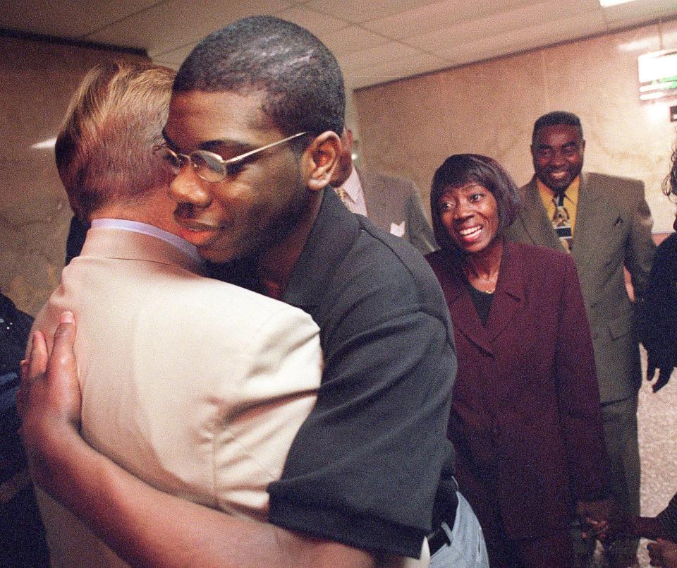 In November 2000, 16-year-old Brenton Butler hugs Patrick McGuinness, one of his public defenders, after a jury quickly found him not guilty of first-degree murder. Butler's mother, Melissa Butler, watches behind the two.