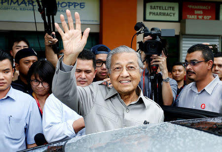 Former Malaysian Prime Minister Mahathir Mohamad waves as he leaves after he was stopped from visiting jailed opposition leader Anwar Ibrahim who is recuperating from a surgery at Cheras Rehabilitation Hospital in Kuala Lumpur, Malaysia January 10, 2018. REUTERS/Lai Seng Sin