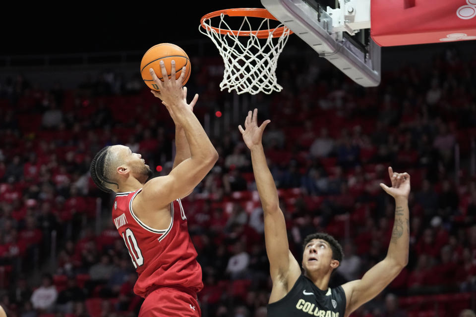 Utah guard Marco Anthony (10) goes to the basket as Colorado guard Nique Clifford, right. defends during the second half of an NCAA college basketball game Saturday, Feb. 11, 2023, in Salt Lake City. (AP Photo/Rick Bowmer)