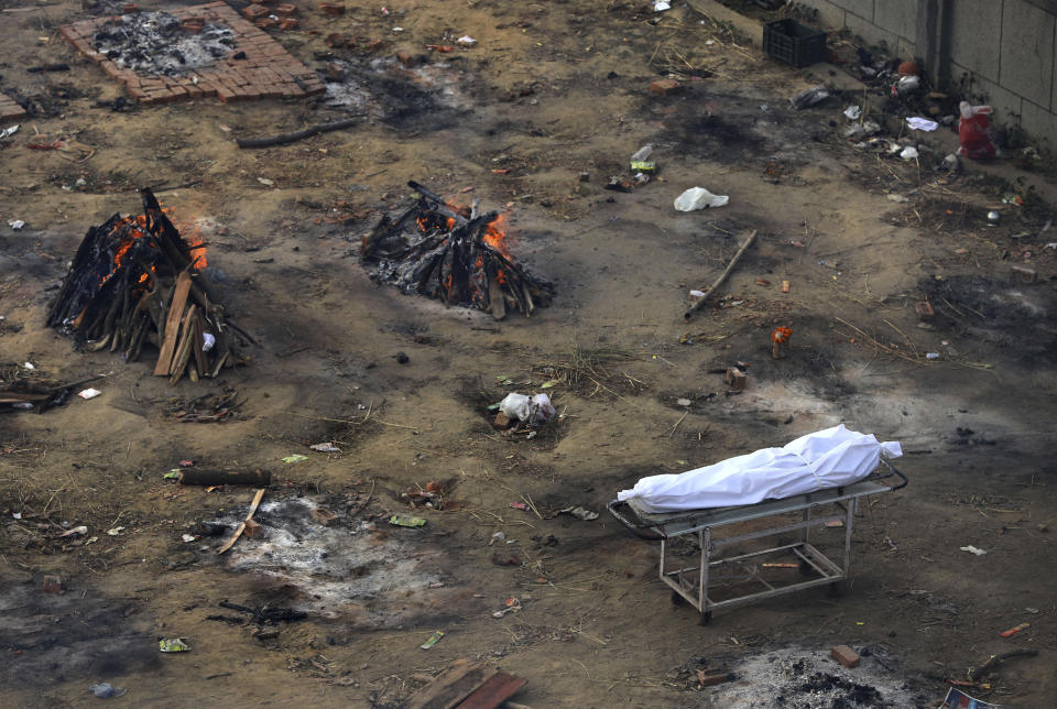 Multiple funeral pyres of those patients who died of COVID-19 disease are seen burning at a ground that has been converted into a crematorium for mass cremation of coronavirus victims, in New Delhi, India, Wednesday, April 21, 2021. (AP Photo)