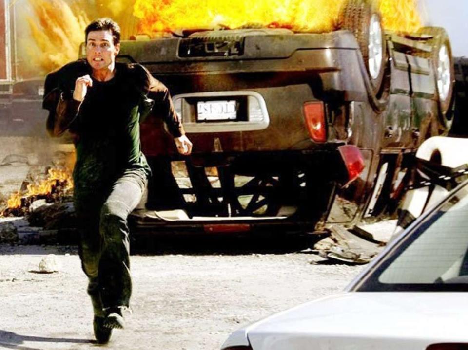 Tom Cruise in "Mission: Impossible III" running from a burning car
