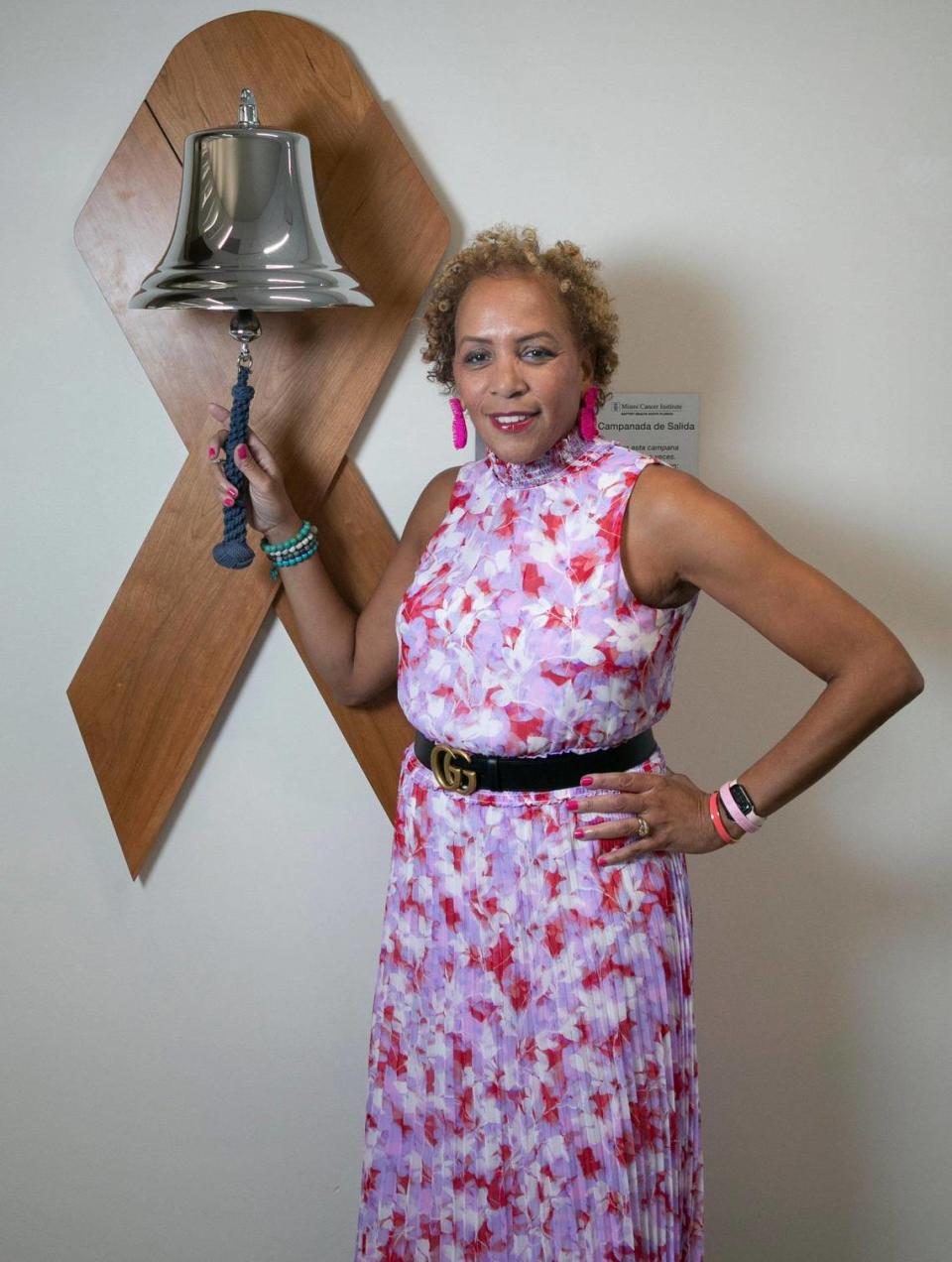 Angela Taylor stands at the bell she rang after her last treatment for breast cancer at Baptist Health’s Miami Cancer Institute Plantation location. Taylor is a breast cancer survivor and a patient of Dr. Lauren Carcas.