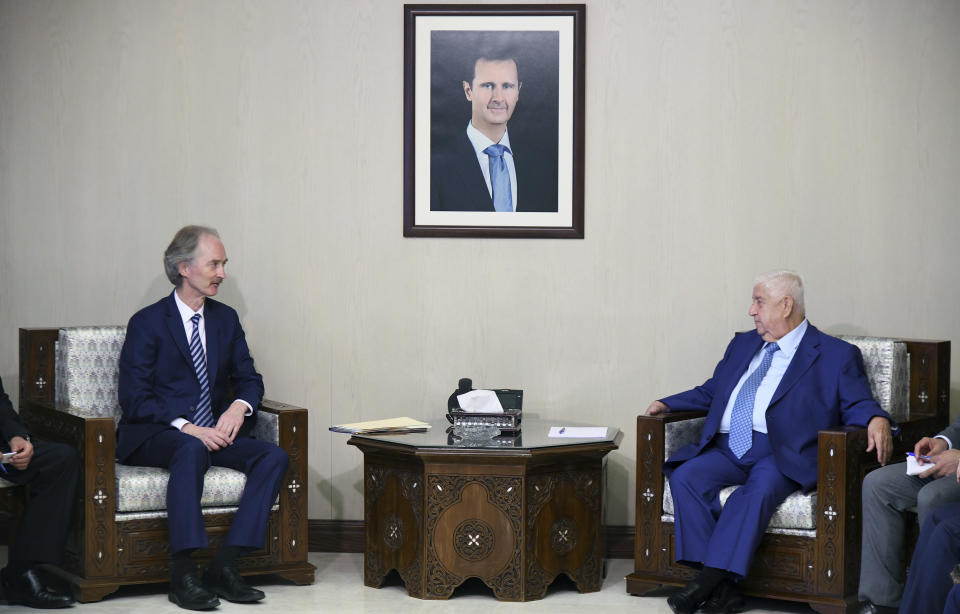 In this photo released by the Syrian official news agency SANA, the U.N.'s special envoy for Syria Geir Pedersen, left, meets with Syrian Foreign Minister Walid al-Moallem, in Damascus, Syria, Monday, Sept. 23, 2019. Syria's state news agency SANA said Monday that al-Moallem discussed the formation of a constitutional committee and its work with Pedersen. SANA said al-Moallem's meeting with Pedersen on Monday focused on the committee's setup and guarantees that it be free "from any foreign intervention." (SANA via AP)