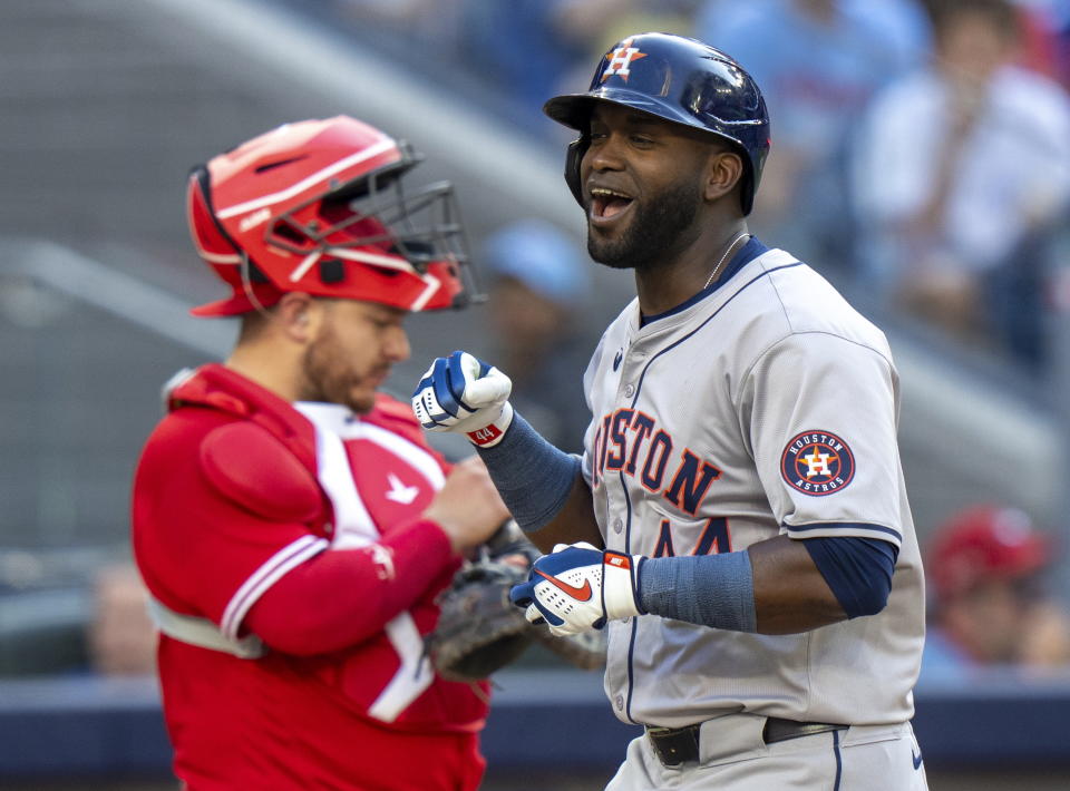 Houston Astros designated hitter Yordan Alvarez, right, celebrates in front of Toronto Blue Jays catcher Alejandro Kirk, left, as he crosses the plate after hitting a two-run home run in ninth-inning baseball game action in Toronto, Monday, July 1, 2024. (Frank Gunn/The Canadian Press via AP)