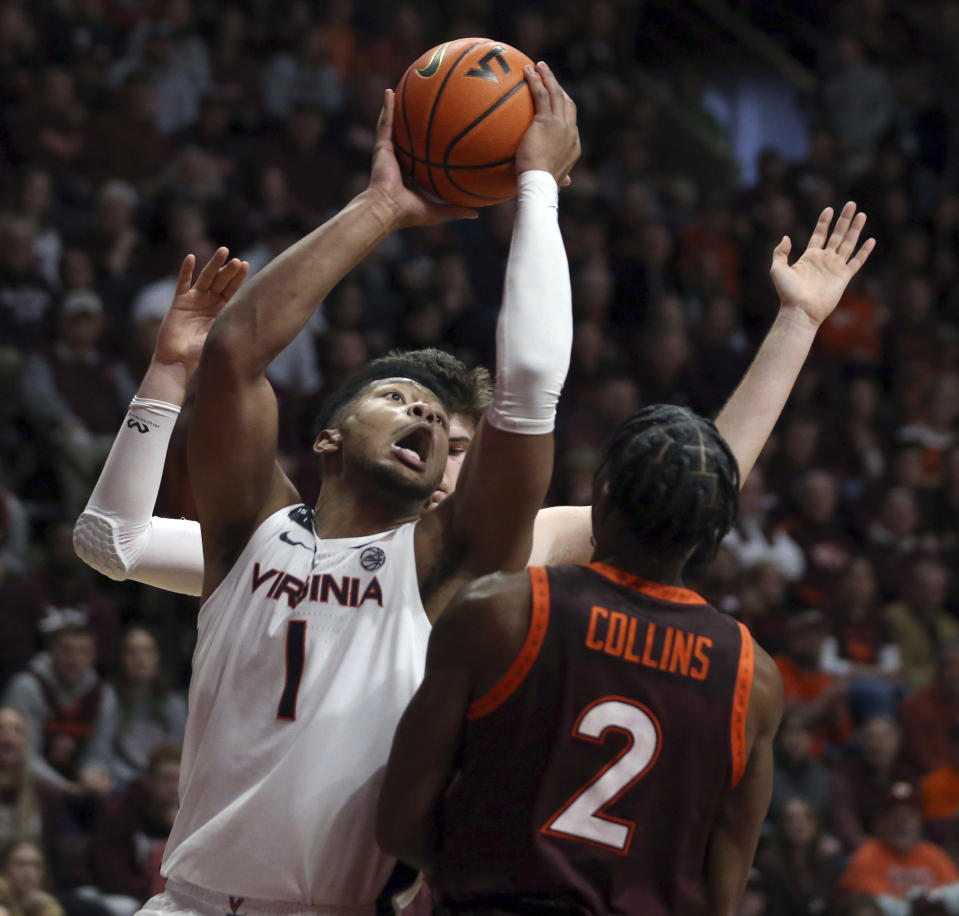 Virginia's Jayden Gardner (1) drives on Virginia Tech's Michael Collins Jr.(2) in the first half of an NCAA college basketball game in Blacksburg Va., Saturday, Feb. 4, 2023. (Matt Gentry/The Roanoke Times via AP)