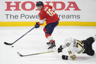 Florida Panthers center Aleksander Barkov (16) and Boston Bruins left wing Jake DeBrusk (74) battle for the puck during the second period of Game 5 of the second-round series of the Stanley Cup Playoffs, Tuesday, May 14, 2024, in Sunrise, Fla. (AP Photo/Wilfredo Lee)