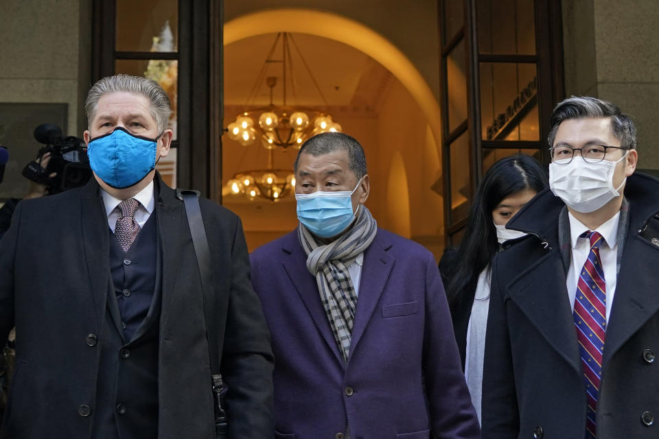 Hong Kong pro-democracy activist and media tycoon Jimmy Lai, center, leaves the Court of Final Appeal during a break in Hong Kong, Thursday, Dec. 31, 2020. Lai appeared in court Thursday as prosecutors asked the city's top judges to send him back to detention after he was granted bail last week on fraud and national security-related charges. (AP Photo/Kin Cheung)