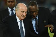 Issa Hayatou (right) has taken over as interim FIFA president following the suspension of Sepp Blatter (left)