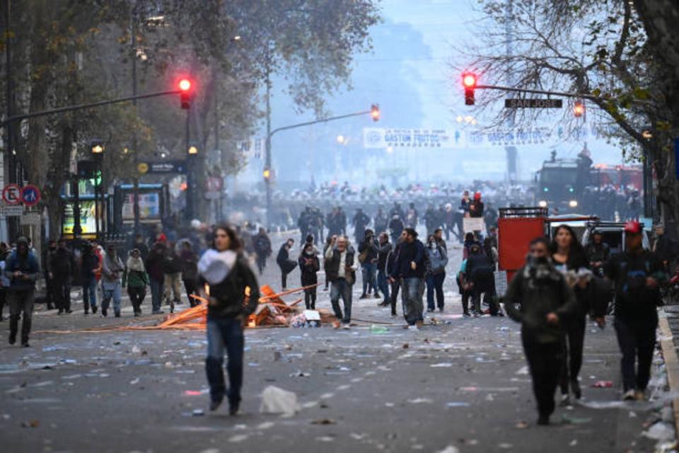 Demonstrators clash with riot police during a protest near the National Congress in Buenos Aires on 12 June 2024 (AFP via Getty Images)