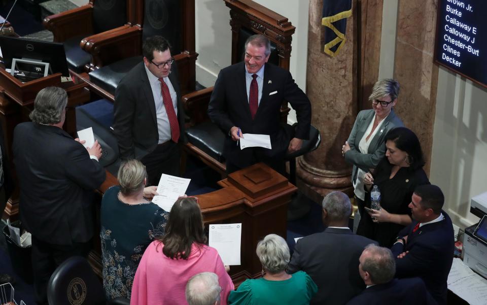 Kentucky Speaker of the House David Osborne, center, talks with legislators in House chambers on the last day of the legislative session at the Capitol on March 30, 2023.